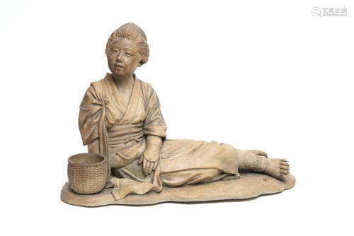 A soft paste light brown figure of a reclining farm girl