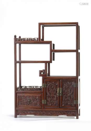 A small Chinese hardwood dragon display cabinet