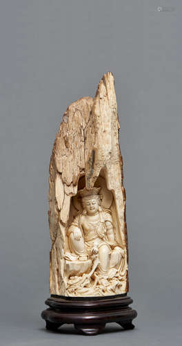 A Chinese ivory figure of Guanyin in a grotto