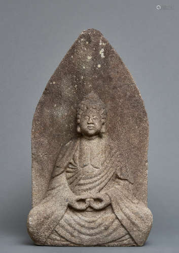 A Volcanic rock roadside stone with a relief depicting a Buddha