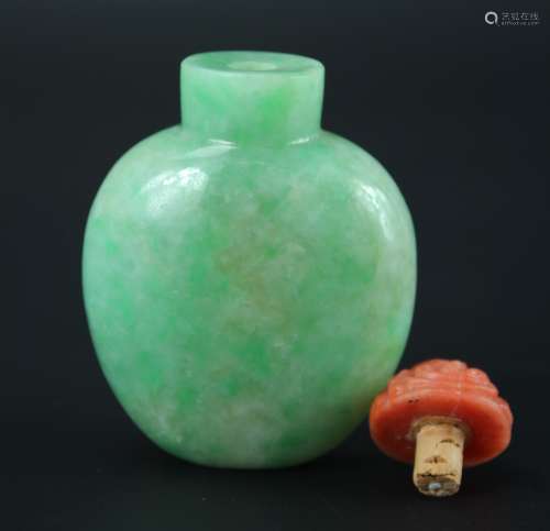 Jadite snuffle bottle with red coral stopper from Qing dynasty
