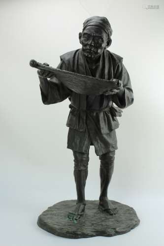 A finely detailed bronze figure of a Japanese man with sifter