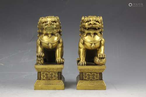 A pair of small brass foo lions