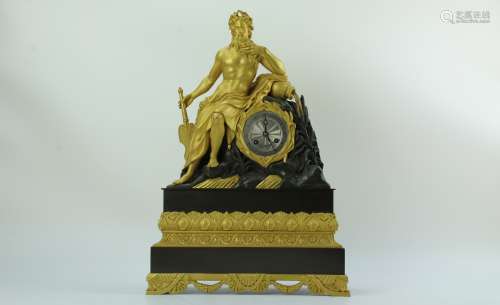A shiny gilted brass clock with Dionysus holding a fan