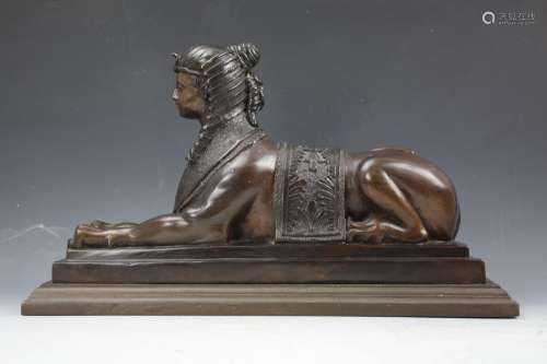 Bronze statue of Sphinx on wooden base