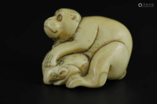 Vintage Netsuke carving of a man on top of a crab