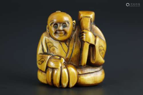 Vintage Netsuke carving of a man with extendable eyes with old patina