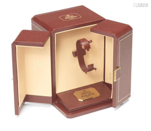 Patek Philippe. A burgundy leather covered electric watch winding box