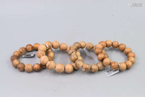 FOUR AGARWOOD BEAD BRACELETS