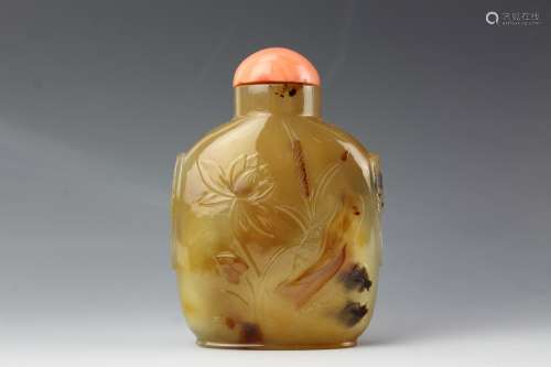 Chinesepale agate snuff bottle with coral stopper. Low relief carved lotus with mandarin ducks and crane. 19th century
