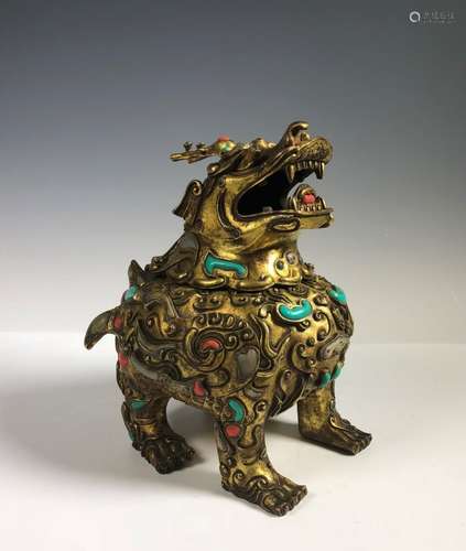 A Gilt Bronze Figure Of Foo Dog With Stone Inlay