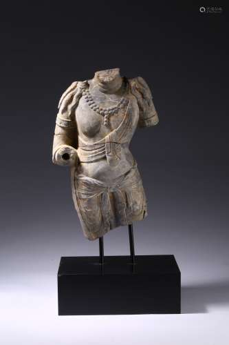 A limestone carved torso of standing bodhisattva
