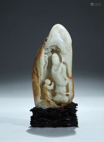 A white jade carved 'Guanyin and child' boulder with skin