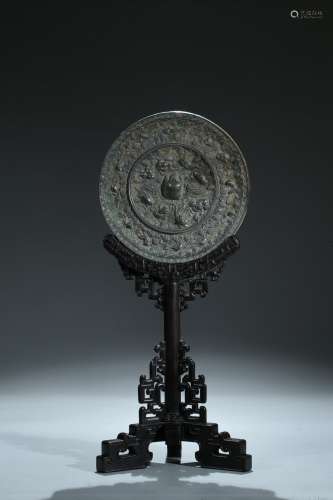 A bronze 'lion and grapevine' mirror and stand