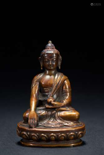 A small bronze figure of seated Shakyamuni