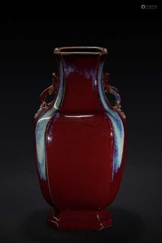 A large red flambe-glazed vase