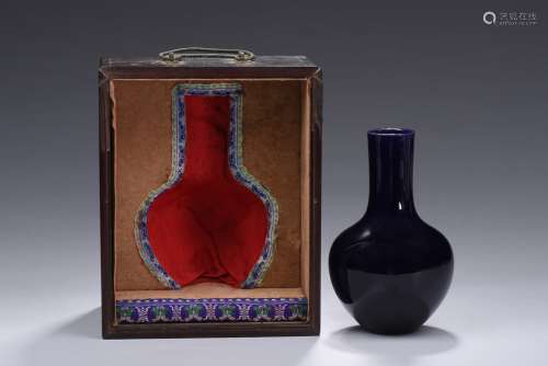 A small blue glaze bottle vase