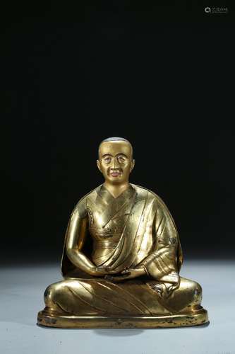 A gilt bronze figure of lama with inscription