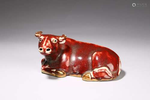 A flambé-glazed model of recumbent buffalo