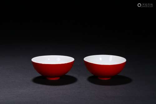 A pair of red glazed bowls