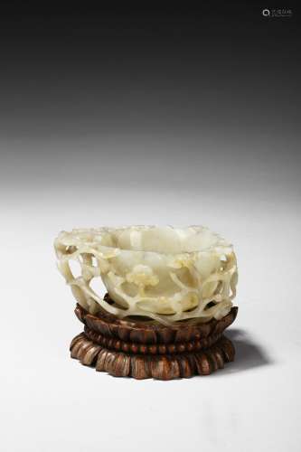 A white jade reticulated 'plum blossom and chilong' washer