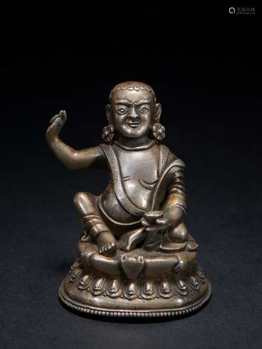 A small silver figure of milarepa