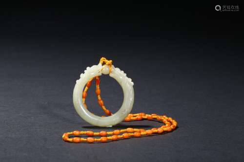 A white jade dragon ring pendant