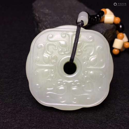 A WHITE CARVED HETIAN JADE, BI