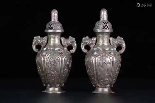 PAIR OF SILVER CARVED BOTTLE VASES