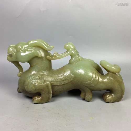 A CARVED  HETIAN JADE BEAST PENDANT