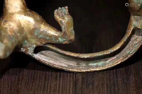 A GILT BRONZE CARVED BEAST PENDANT