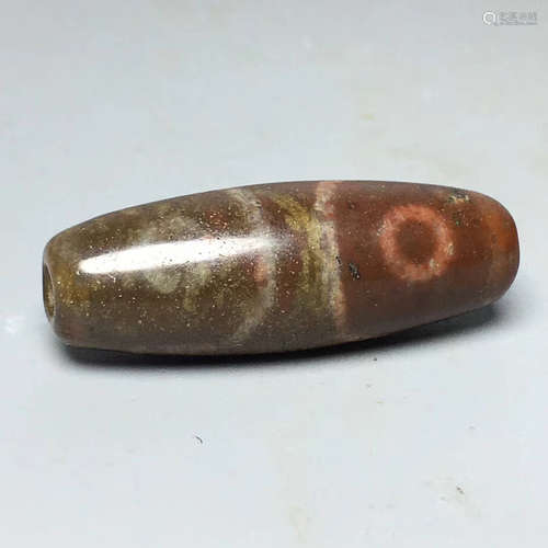 A TIBETAN THREE-EYE DZI BEAD