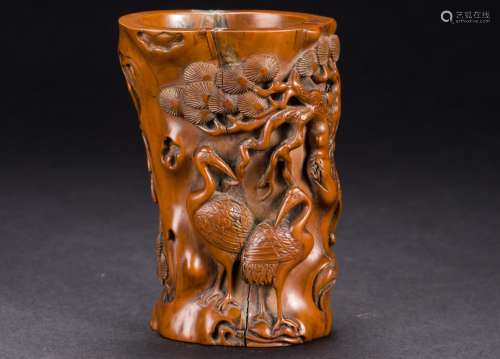 A Chinese carved pine and crane brush pot from Qing Dynasty