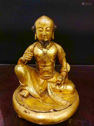 A GILT BRONZE CARVED FIGURE OF BUDDHA