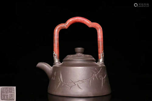 A YIXING ZISHA CARVED TEAPOT