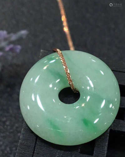 A NATURAL JADEITE RING SHAPED PENDANT