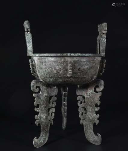 A BRONZE TRIPOD VESSEL