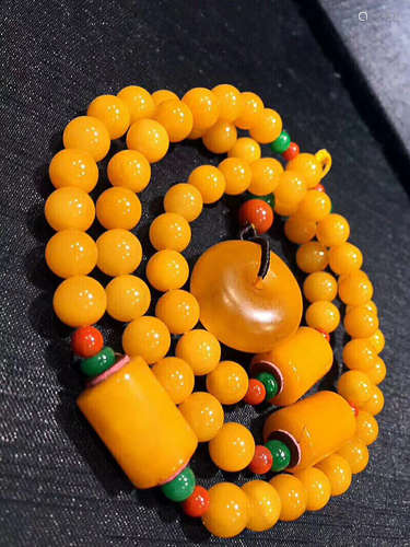 AN OLD BEESWAX PEACE BUCKLE DESIGN NECKLACE