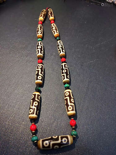 AN OLD BLACK NINE EYES DZI BEAD NECKLACE