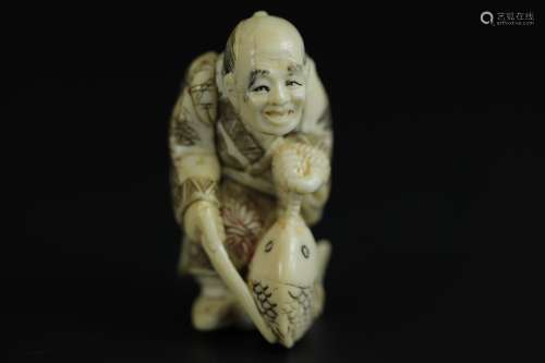 Japanese Netsuke carving of a man carrying a fish