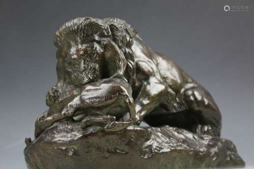 Bronze figure Lion devouring a boar signed by Barye