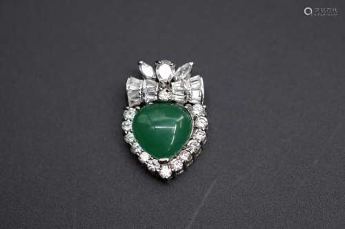 A heart-shaped jadeite surrounded with crystals pendant