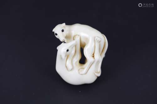 A Carved Netsuke of Two Dogs with Inlay Eyes Signed