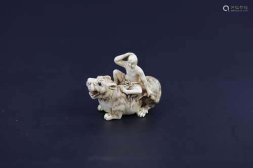 A Carved Netsuke of A Lohan Riding a Tiger with Inlay