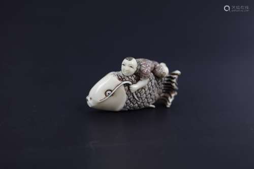 A Carved Netsuke of A Child Riding A Fish Signed