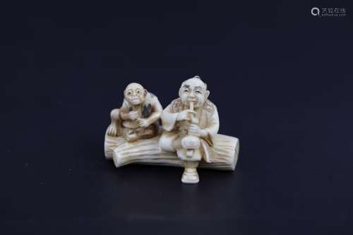 A Carved Netsuke of A Man with Monkey Smoking Pipes