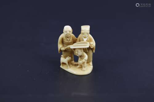 A Carved Netsuke of Grandparents with a Child and a Dog