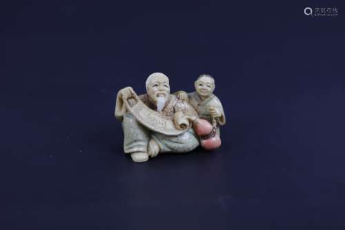 A Carved Netsuke of An Elder Man with A Child Signed