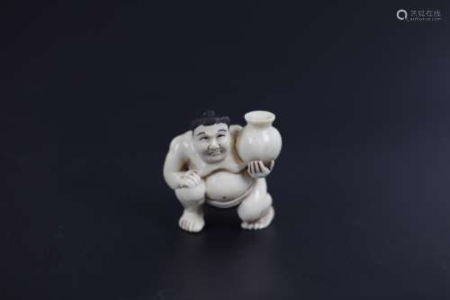 A Carved Netsuke of A Sumo Warrior Holding A Vase