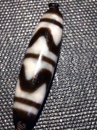 A TIGER-TOOTH DZI BEAD